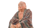 A POLYCHROME POTTERY FIGURE OF A LUOHAN