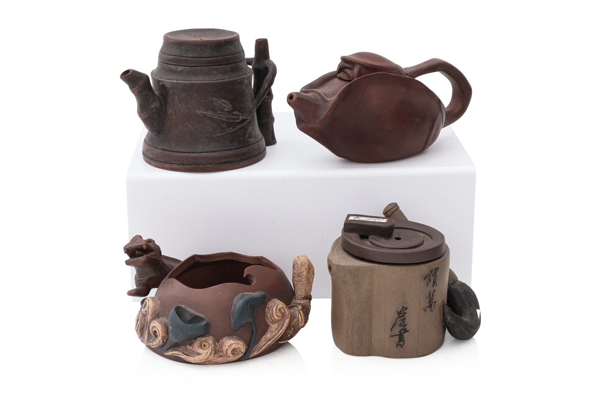 A GROUP OF FIVE YIXING ZISHA POTTERY TEAPOTS AND A BRUSH WASHER