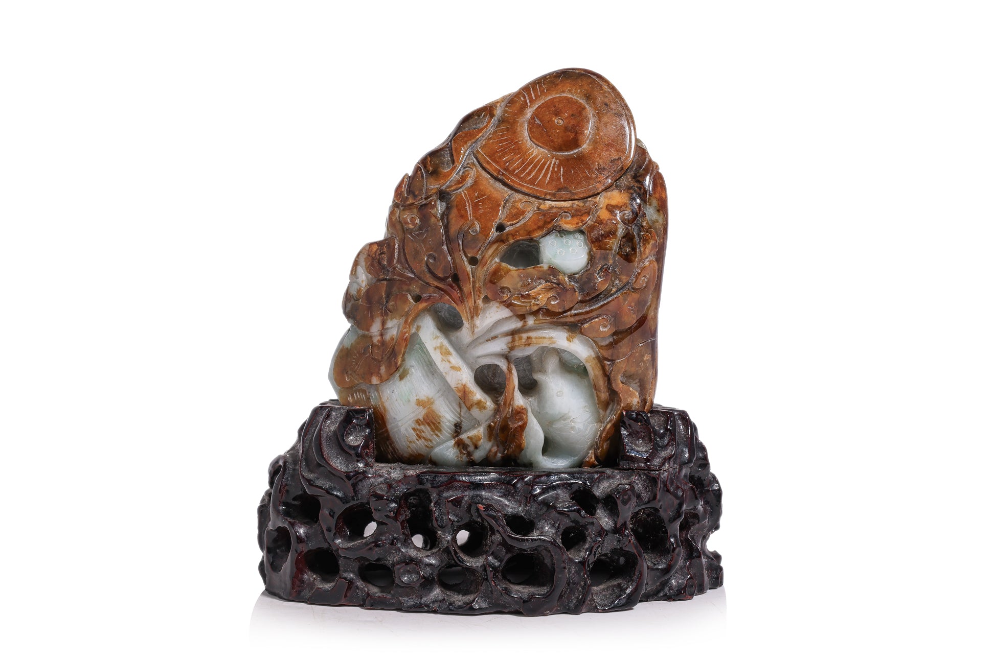 A CARVED GREEN AND RUSSET JADEITE BOULDER