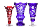 THREE LARGE COLOURED CUT TO CLEAR CRYSTAL VASES