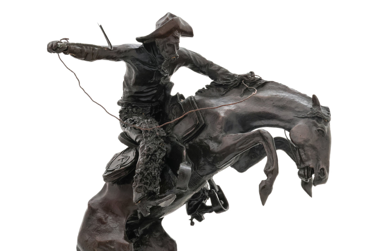 A SPELTER SCULPTURE OF 'WOOLY CHAPS' AFTER THE MODEL BY FREDERIC REMINGTON