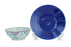 A FAMILLE ROSE CANTON BOWL AND A MONOCHROME BLUE DISH