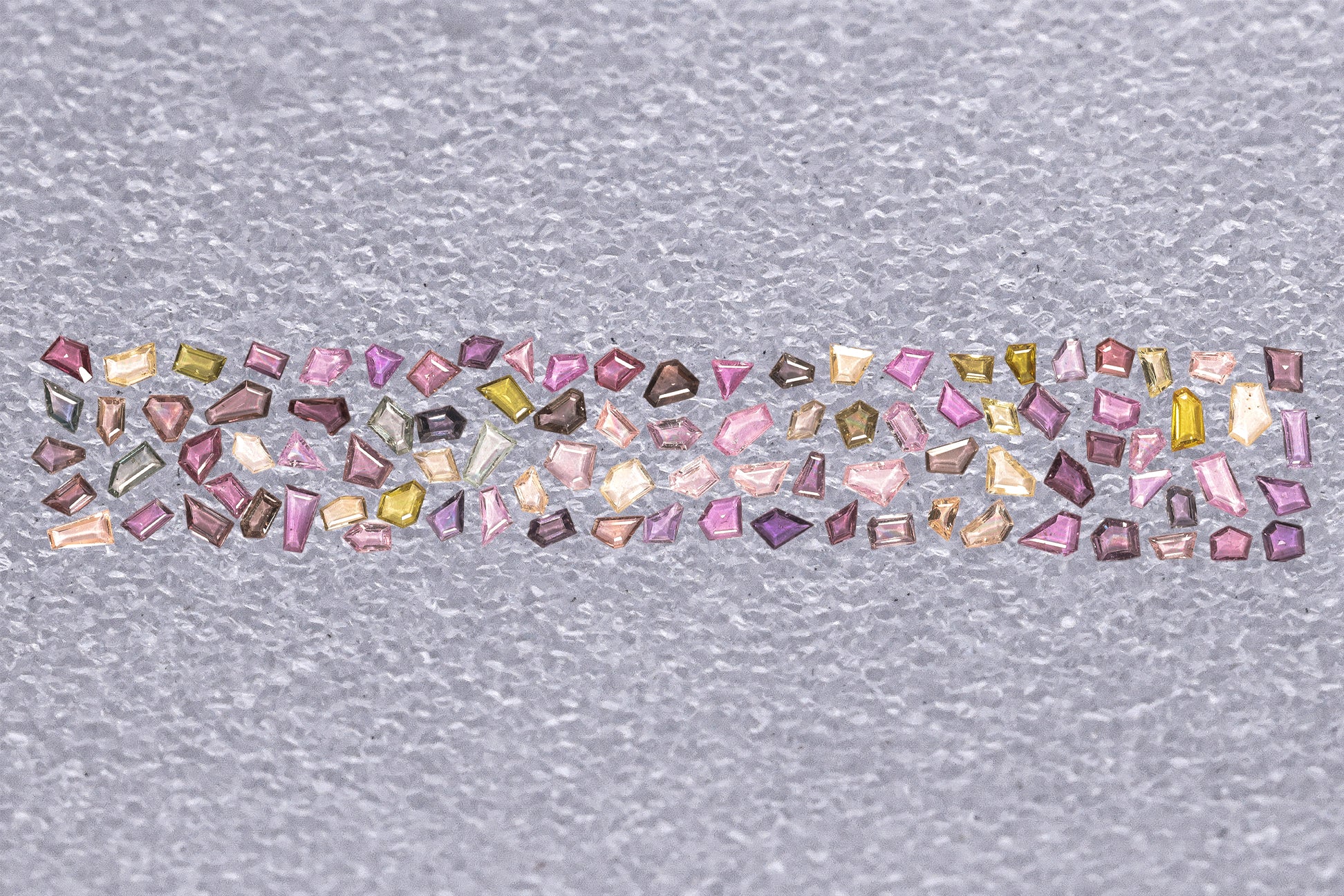 AN UNMOUNTED LAYOUT OF MULTI-COLOUR SAPPHIRE