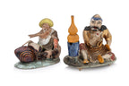 TWO PORCELAIN FIGURES AND A FIGURAL WALL POCKET