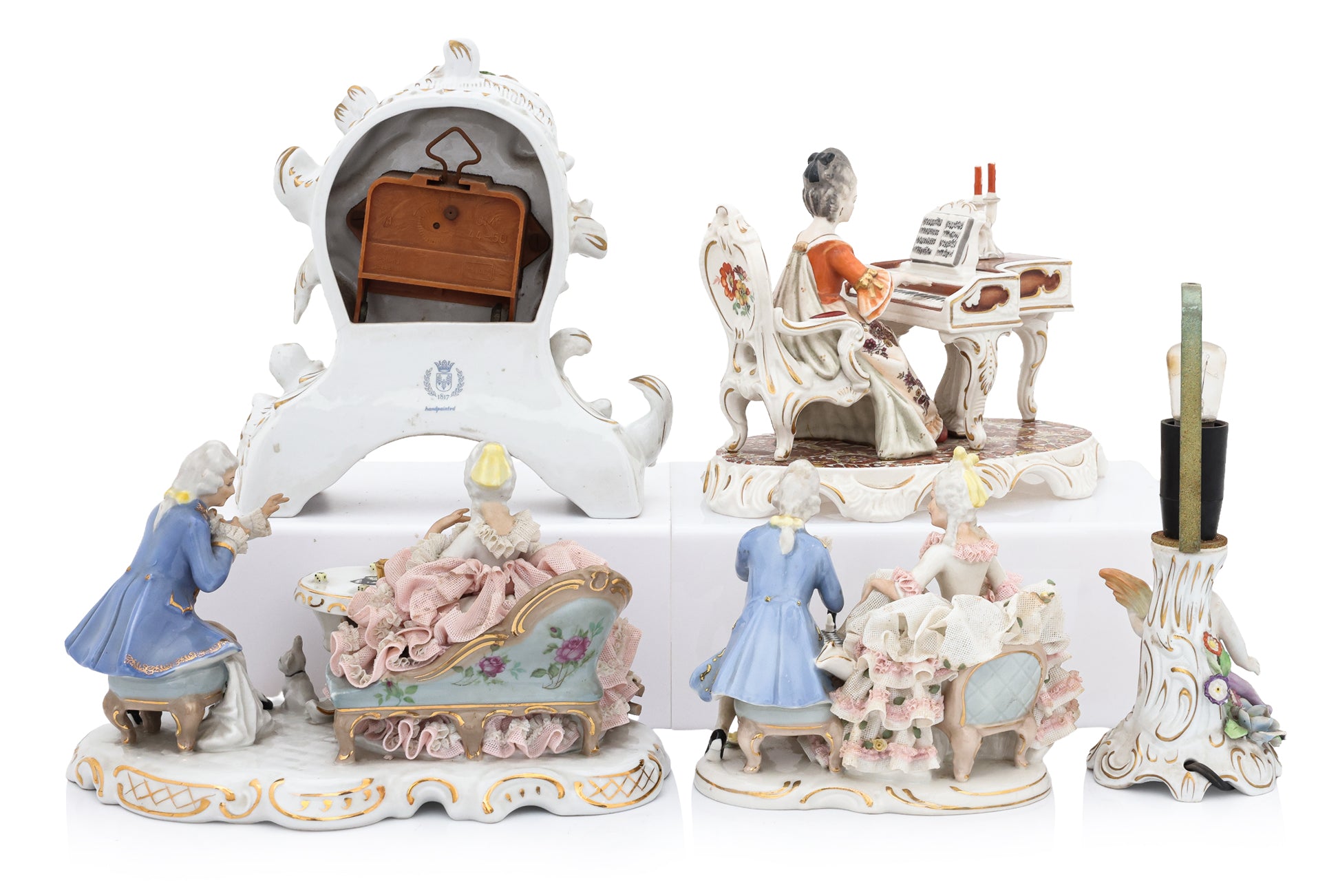 A GROUP OF FIVE GERMAN PORCELAIN FIGURES AND A CLOCK