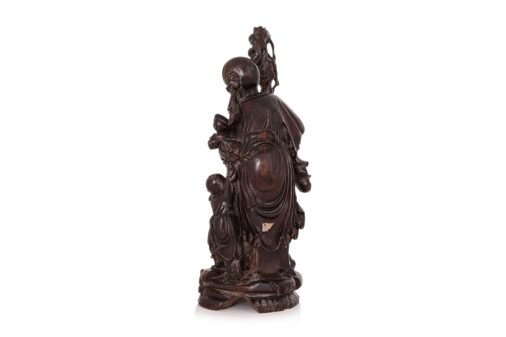 A CARVED HARDWOOD FIGURE OF SHOULAO