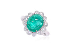 A ZAMBIAN EMERALD AND DIAMOND 'HALO' RING