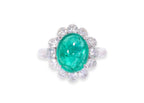 A ZAMBIAN EMERALD AND DIAMOND 'HALO' RING