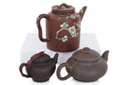 A GROUP OF THREE YIXING POTTERY TEAPOTS