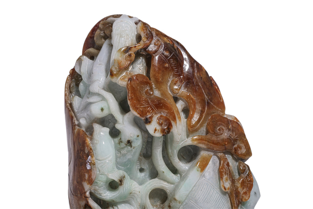 A CARVED GREEN AND RUSSET JADEITE BOULDER
