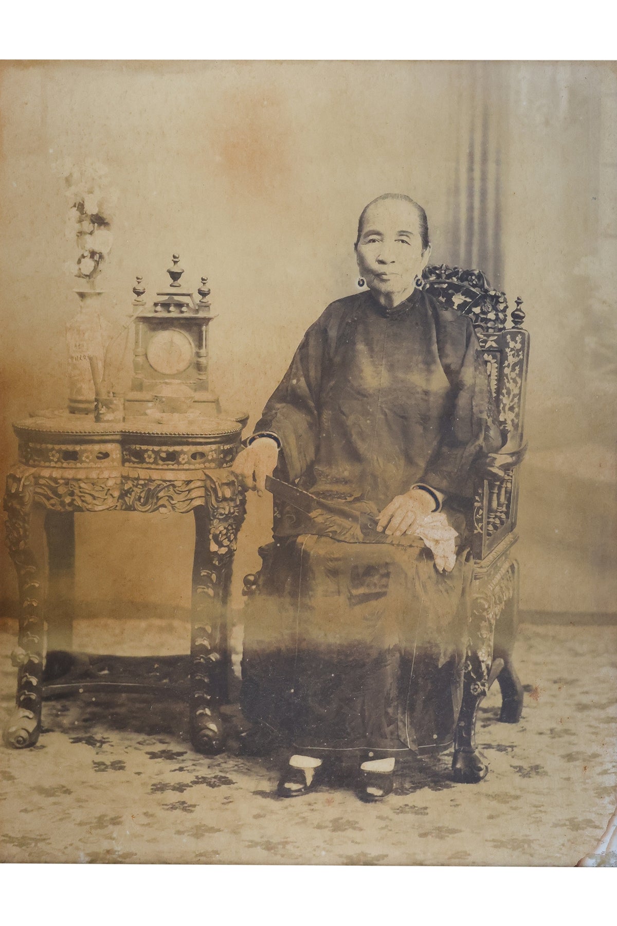 A LARGE-FORMAT PHOTOGRAPHIC PORTRAIT OF A SEATED NYONYA LADY