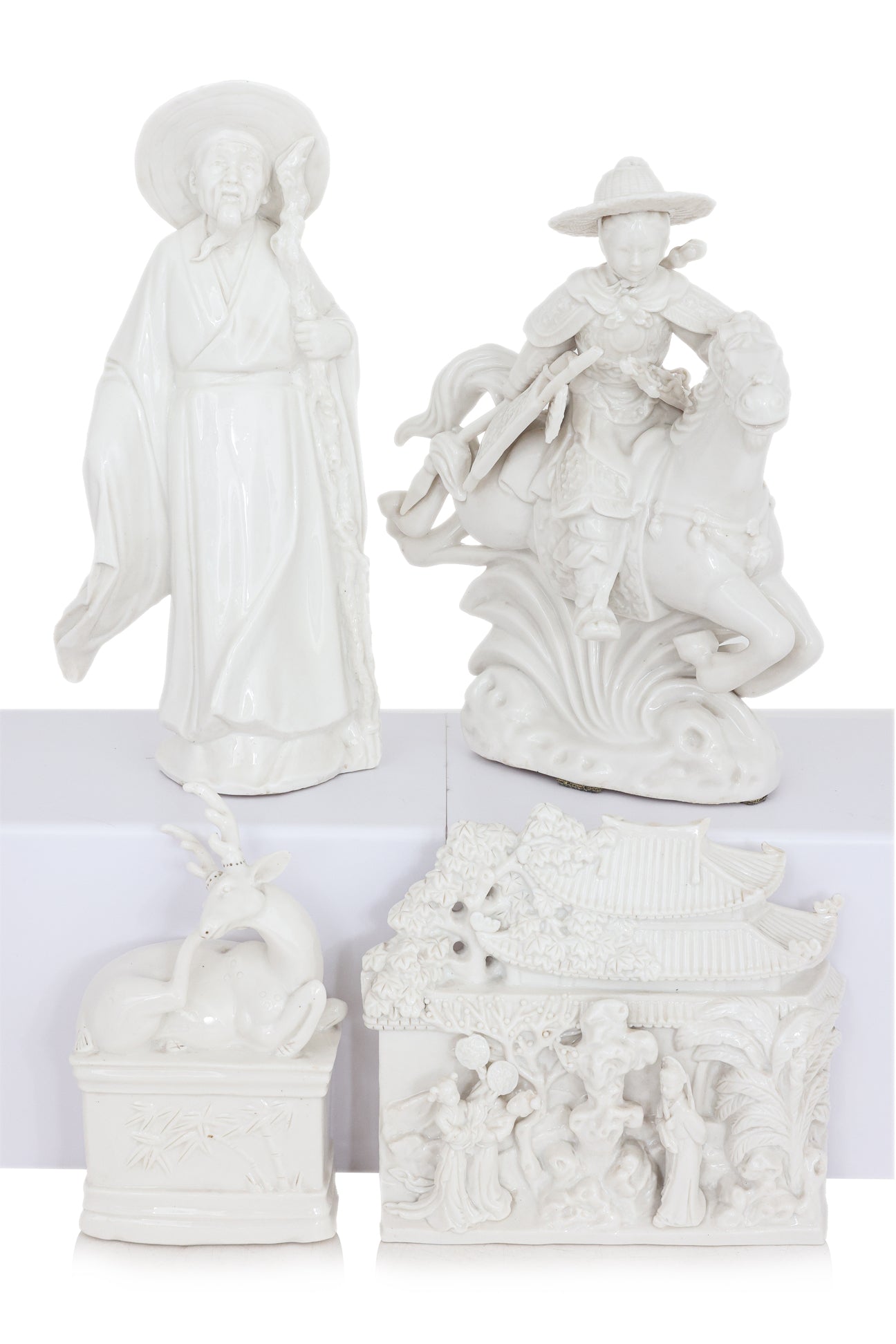A GROUP OF FOUR BLANC DE CHINE PORCELAIN FIGURES