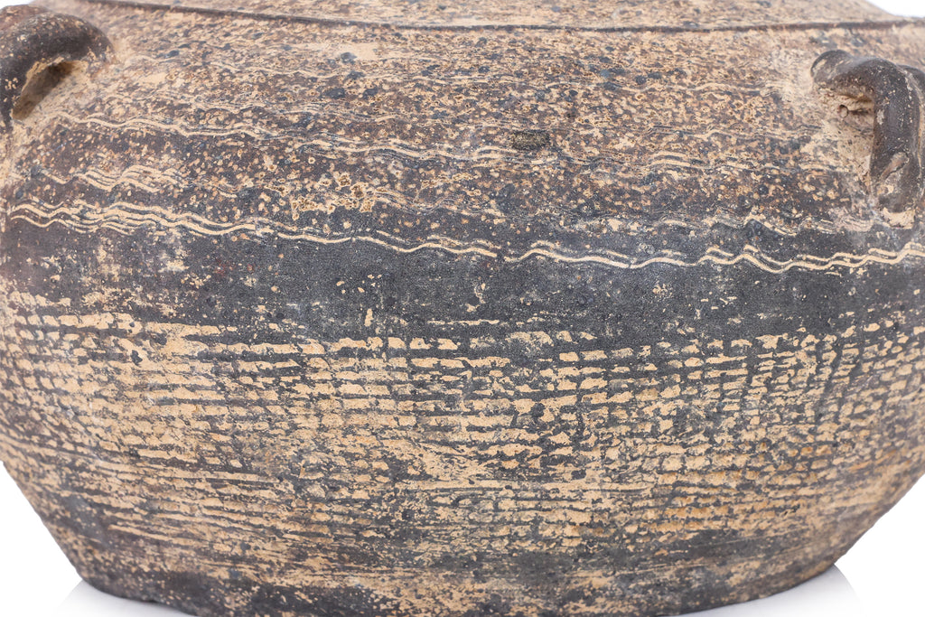 A DARK BROWN EARTHENWARE JAR