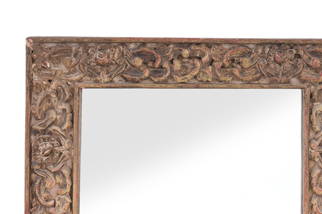 A CARVED AND LACQUERED WOOD FRAMED MIRROR