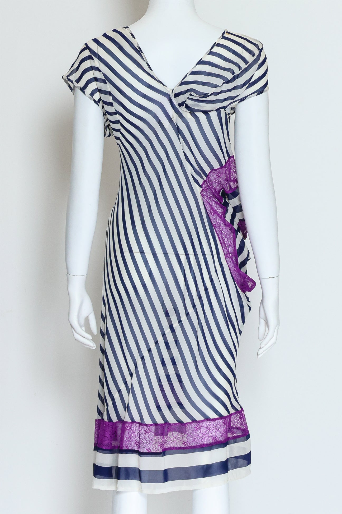 JUNYA WATANABE COMME DES GARÇONS – A BLACK AND WHITE STRIPED DRESS WITH PURPLE LACE