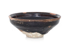 A BLACK-GLAZED STONEWARE BOWL