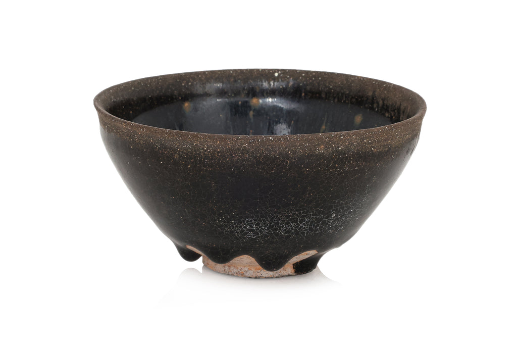 A BLACK GLAZED STONEWARE BOWL
