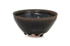 A BLACK GLAZED STONEWARE BOWL