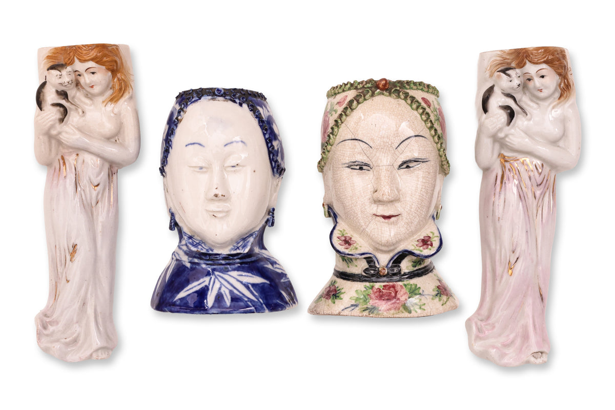 A GROUP OF FOUR FIGURAL PORCELAIN WALL POCKETS