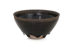 A BLACK GLAZED STONEWARE BOWL