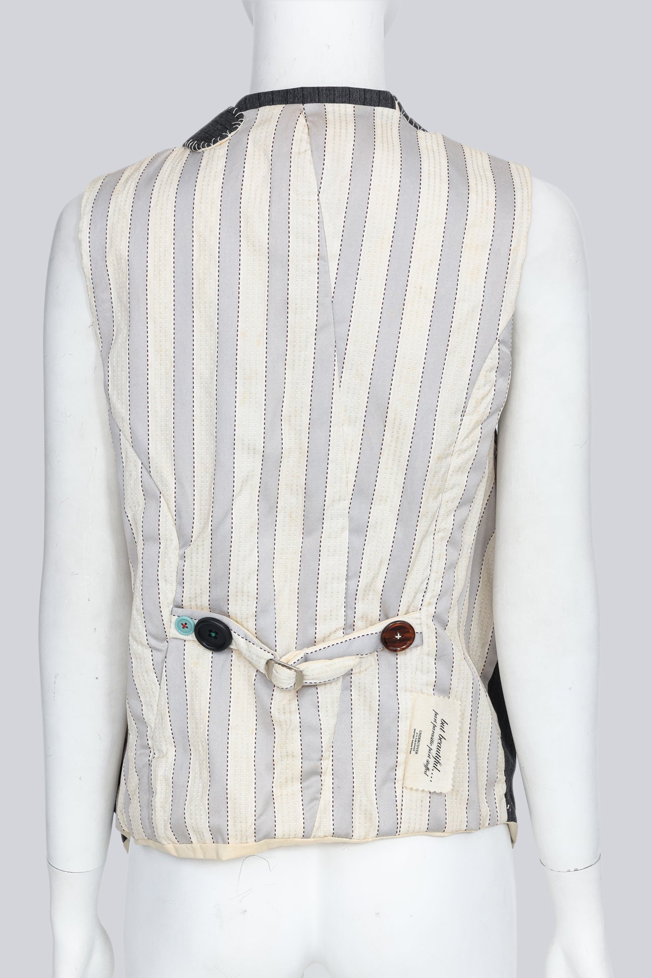 UNDERCOVER JUN TAKAHASHI - AN A/W 2004-2005 SLEEVELESS BLAZER WITH MULTI-COLOURED BUTTONS