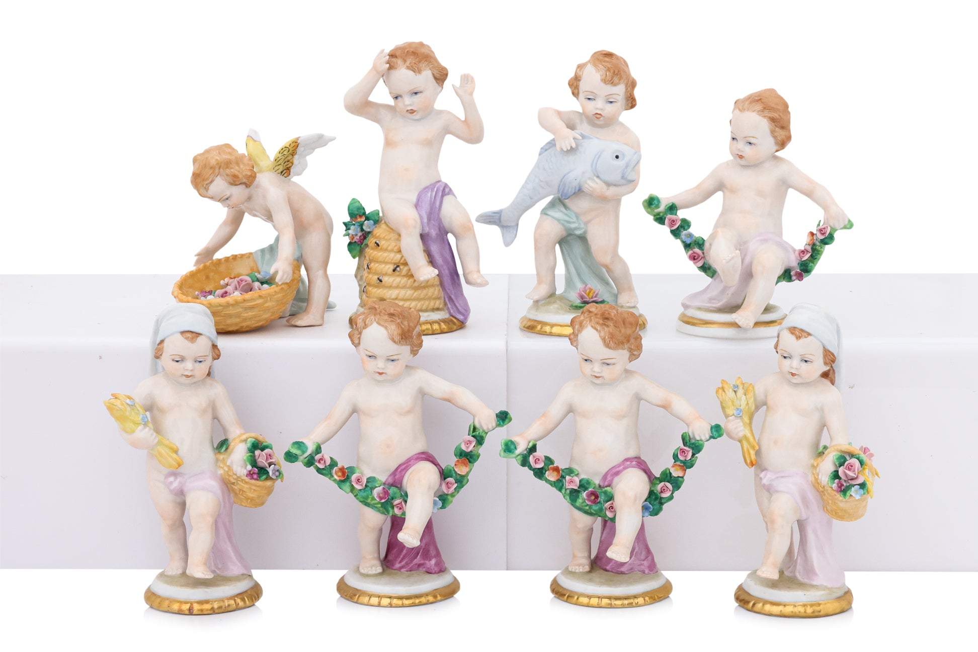 A GROUP OF EIGHT SITZENDORF PORCELAIN FIGURES OF PUTTI