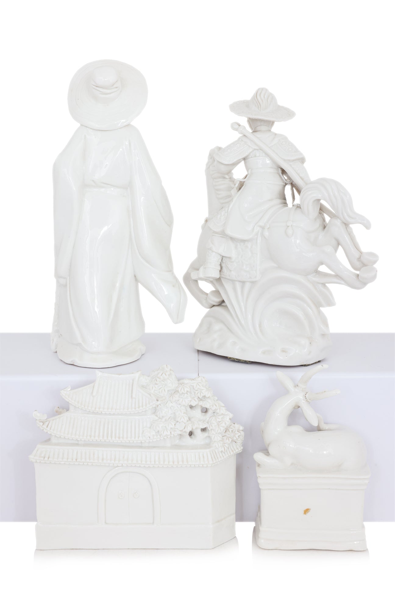 A GROUP OF FOUR BLANC DE CHINE PORCELAIN FIGURES