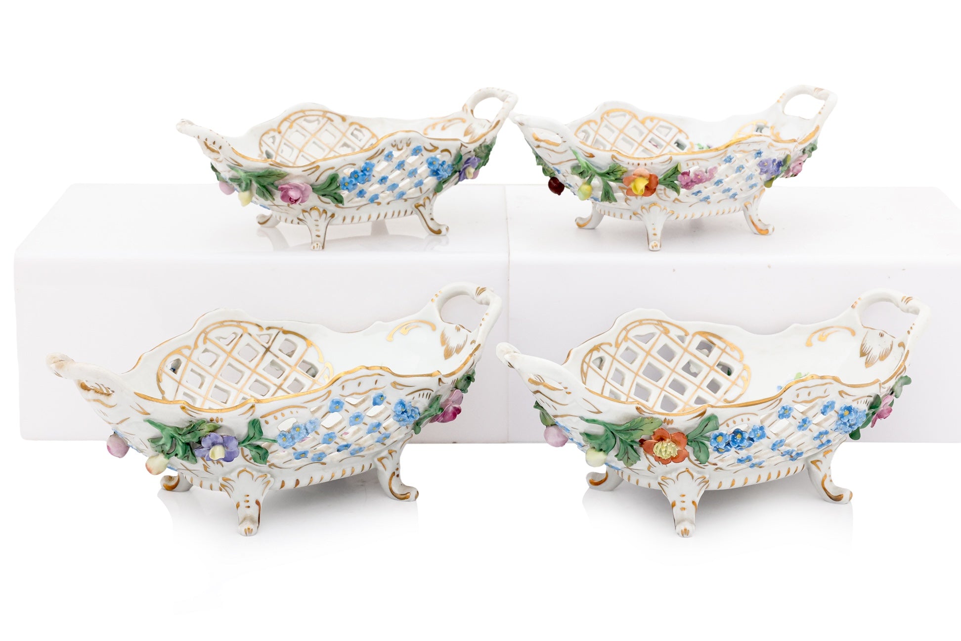 A GROUP OF FOUR DRESDEN PORCELAIN BASKETS