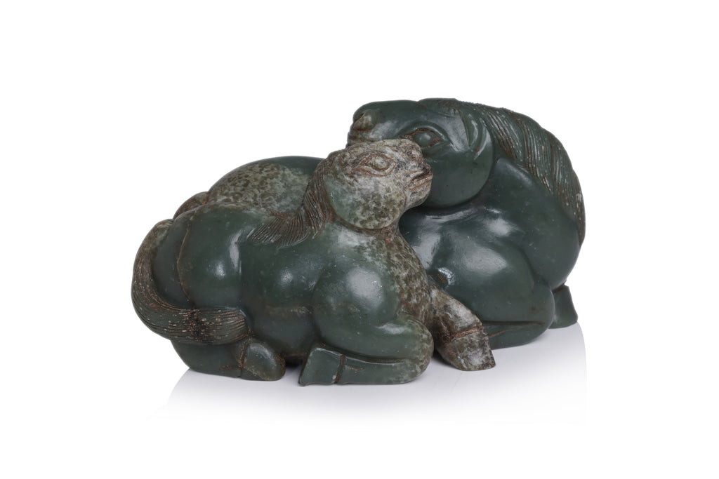A CARVED GREEN JADE HORSES GROUP