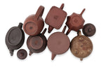 A GROUP OF EIGHT YIXING ZISHA POTTERY TEAPOTS