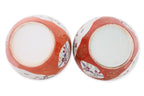 A PAIR OF CORAL GROUND FAMILLE ROSE PORCELAIN JARS