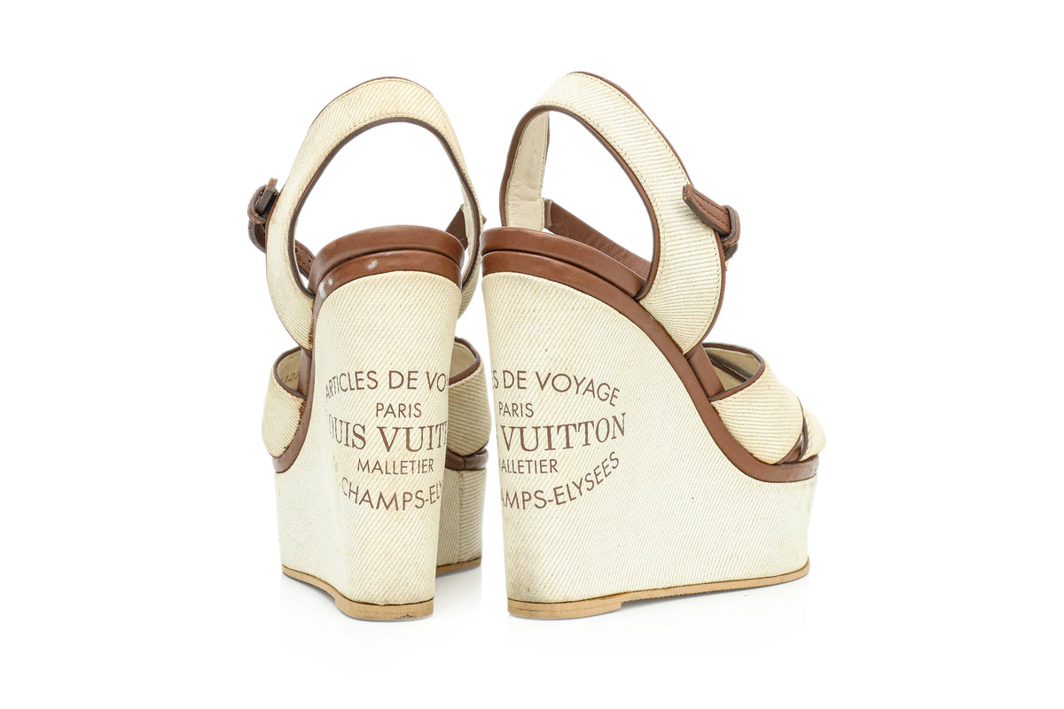 LOUIS VUITTON - A PAIR OF 'ARTICLES DE VOYAGE' SUNLIGHT WEDGE SANDALS