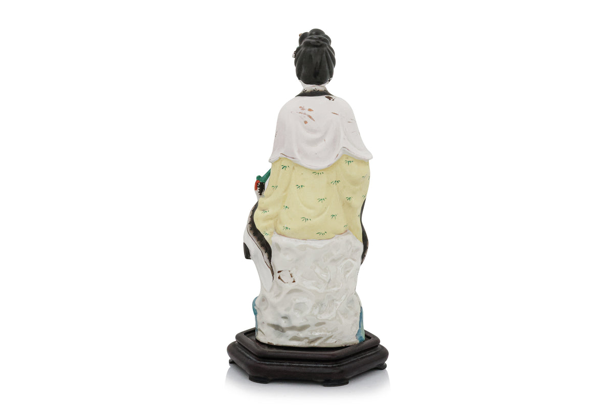 A POLYCHROME-ENAMELLED PORCELAIN FIGURE OF A WOMAN AND BIRD