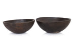 A GRADUATED PAIR OF LARGE WOODEN BOWLS BY CALVIN KLEIN
