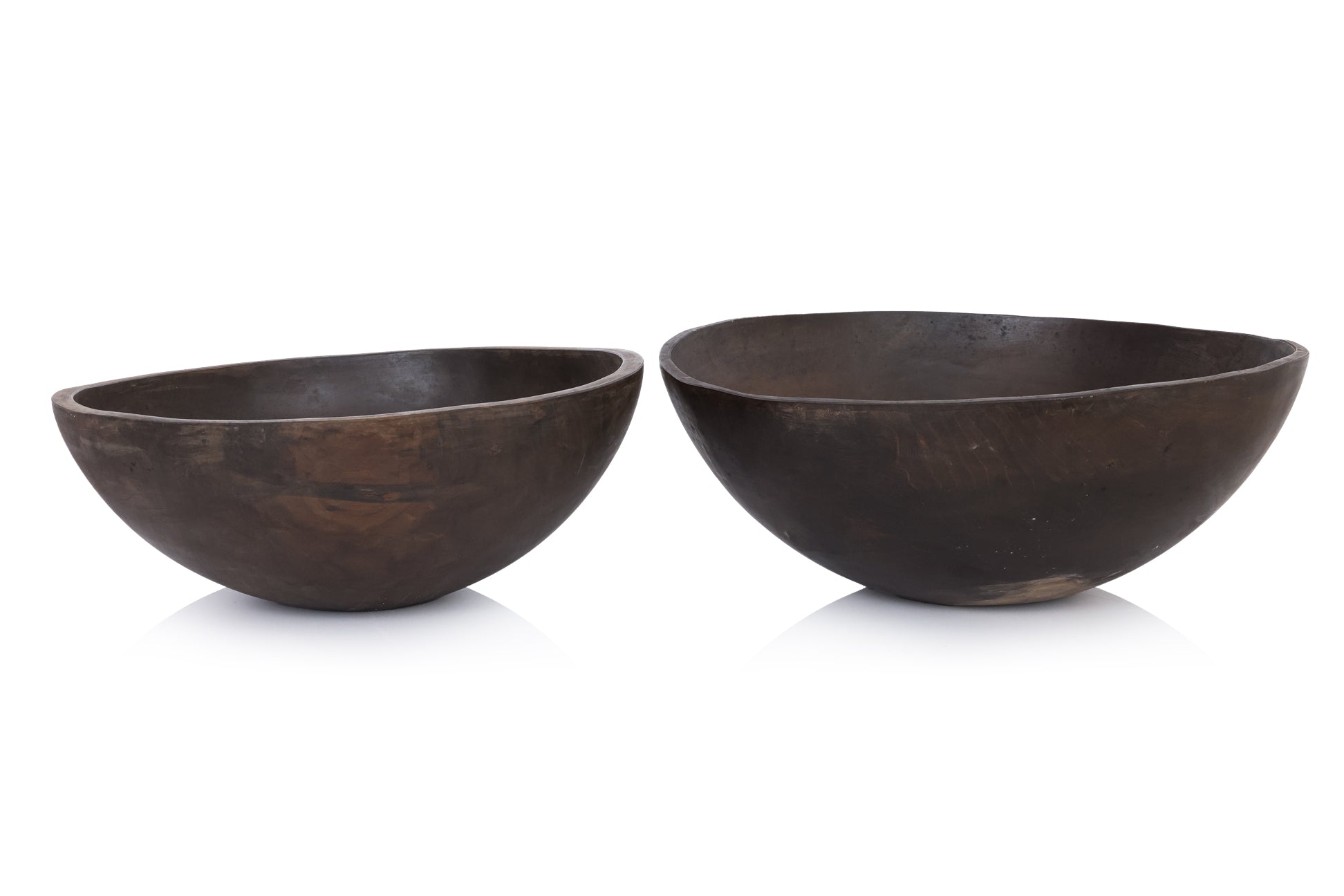 A GRADUATED PAIR OF LARGE WOODEN BOWLS BY CALVIN KLEIN