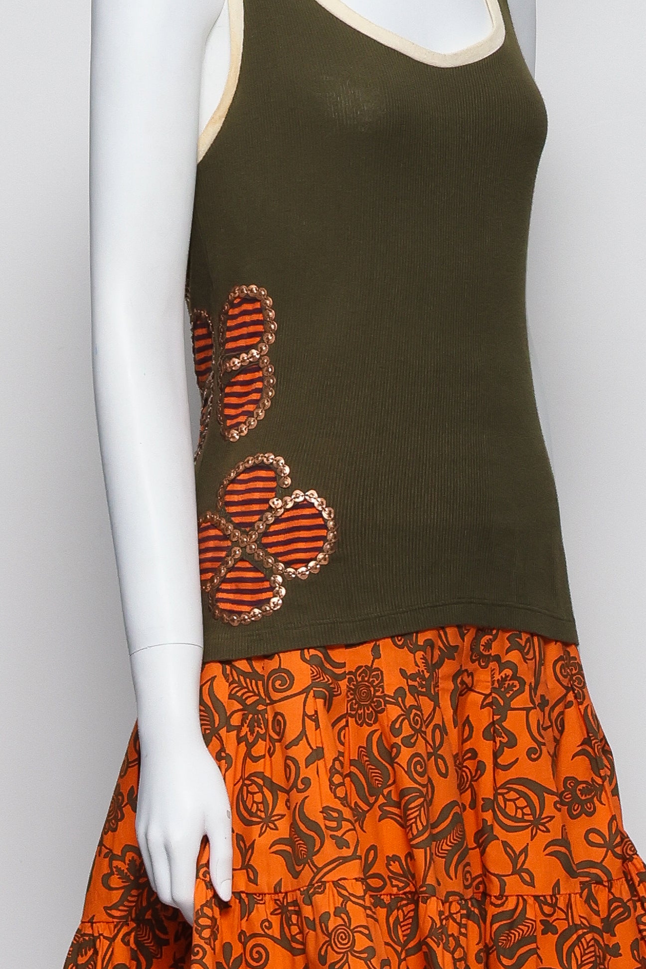 ISABELA CAPETO - AN OLIVE TANK TOP AND ORANGE FLORAL SKIRT
