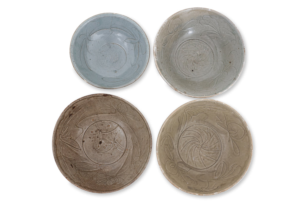 A GROUP OF FOUR CARVED CELADON BOWLS
