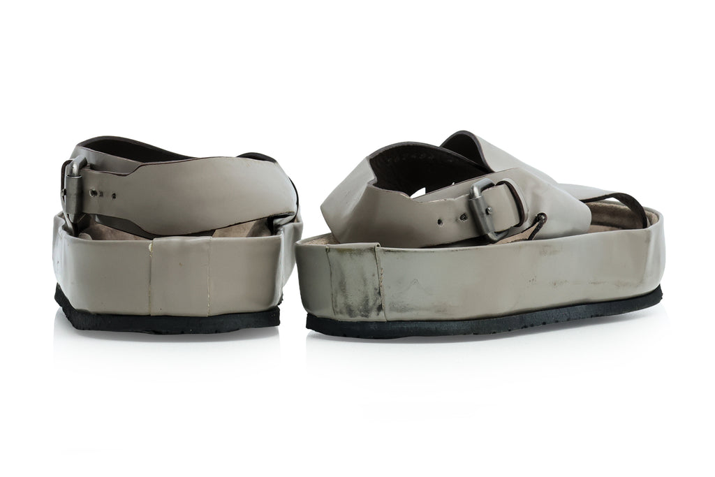 YVES SAINT LAURENT - A PAIR OF GREY LEATHER CROSS-STRAP SANDALS