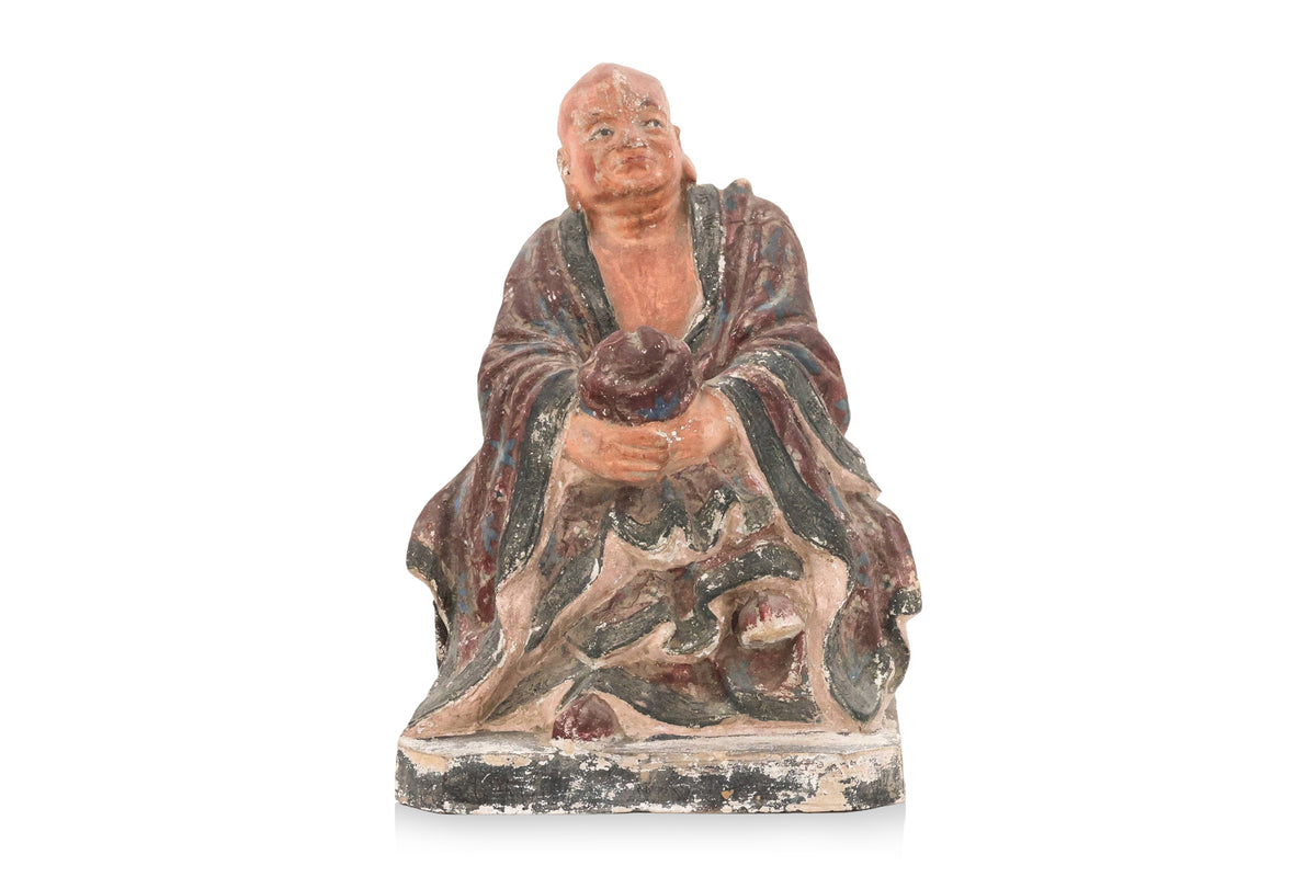 A POLYCHROME POTTERY FIGURE OF A LUOHAN