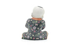 A CHINESE CERAMIC FIGURE OF A SEATED BOY