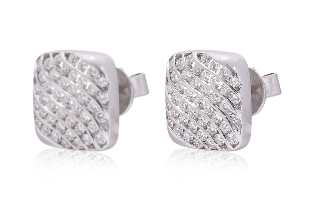 A PAIR OF CHANNEL SET DIAMOND 'WAVE' STUD EARRINGS