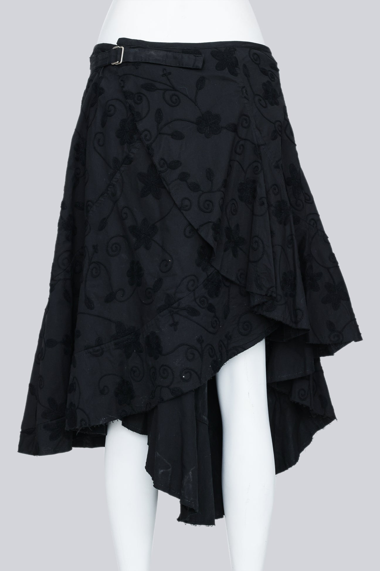 JUNYA WATANABE - A 2002 BLACK EMBROIDERED ASYMMETRICAL WRAP SKIRT WITH A BUCKLE ACCENT