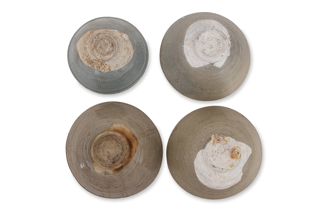 A GROUP OF FOUR CARVED CELADON BOWLS