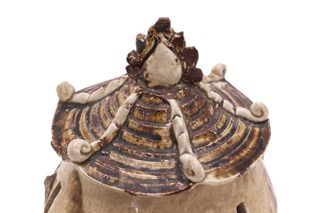 AN EARTHENWARE GRANARY JAR AND COVER