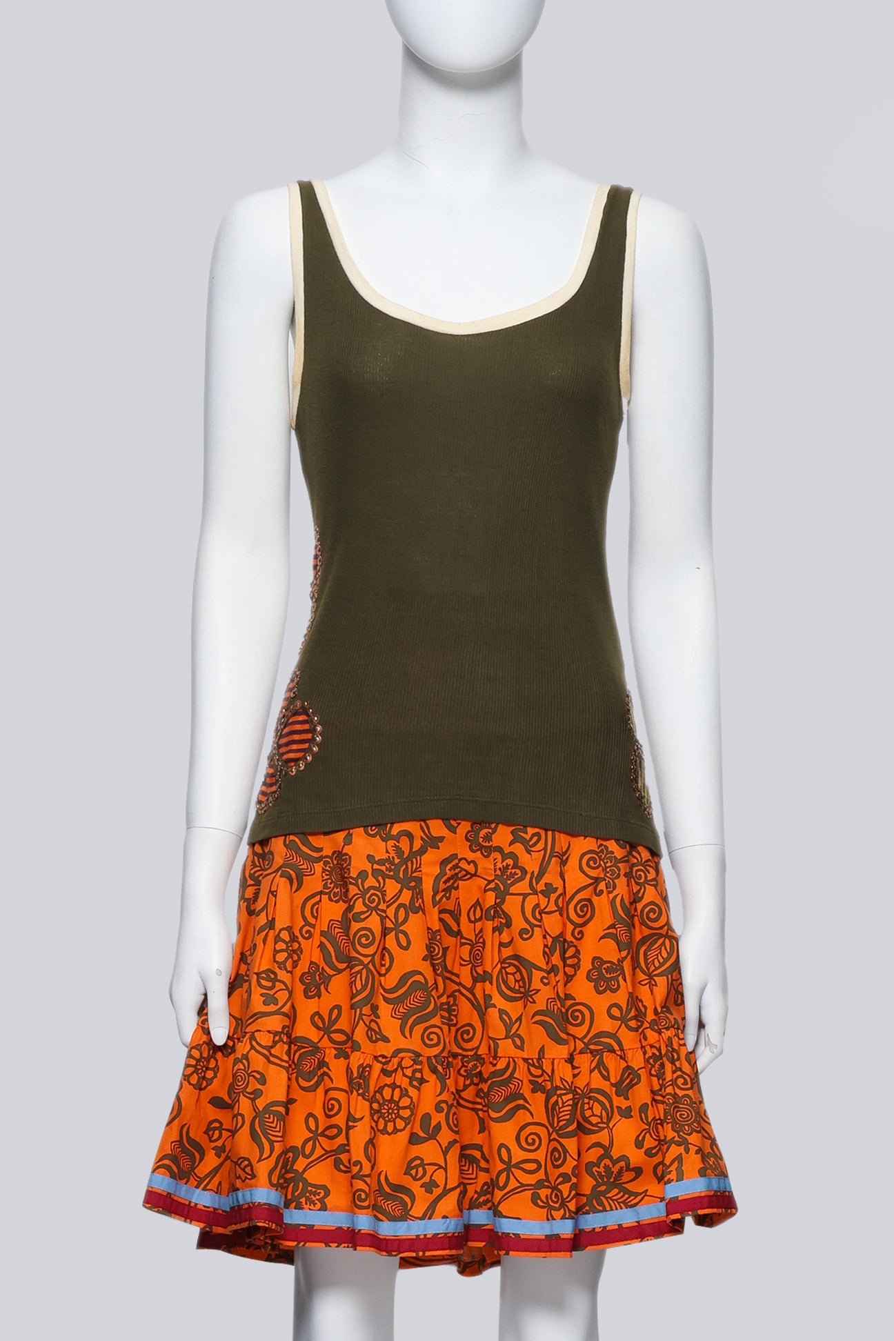 ISABELA CAPETO - AN OLIVE TANK TOP AND ORANGE FLORAL SKIRT