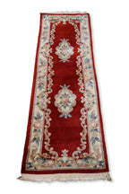 A CHINESE RED FLORAL WOOL HALL RUNNER (69 X 244CM)