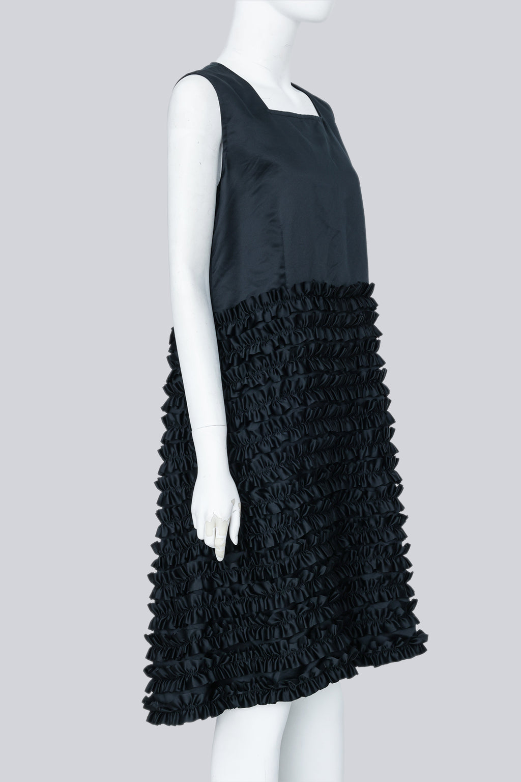 COMME DES GARÇONS - A BLACK SLEEVELESS DRESS WITH RUFFLED SKIRT