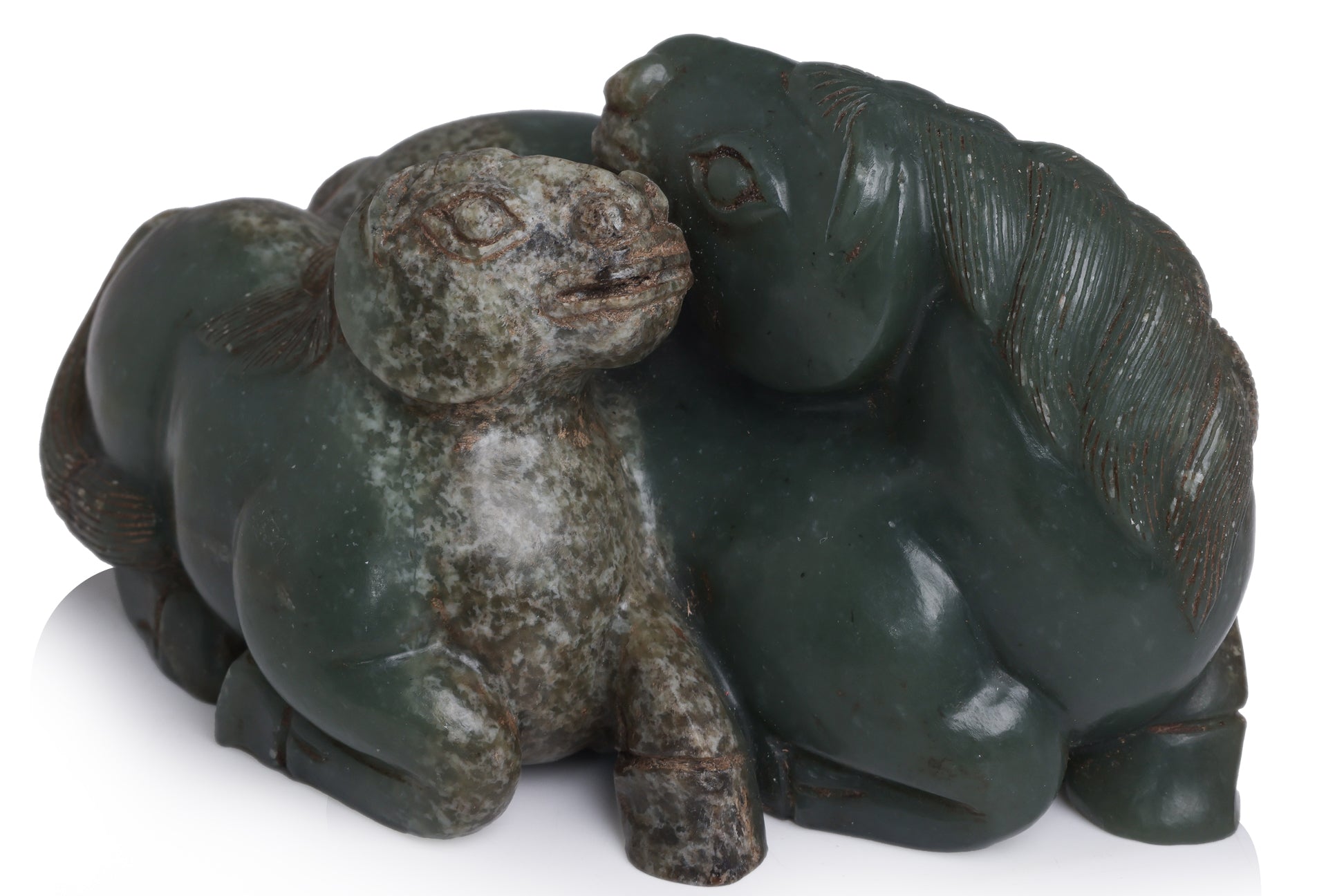 A CARVED GREEN JADE HORSES GROUP