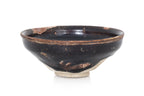 A BLACK-GLAZED STONEWARE BOWL