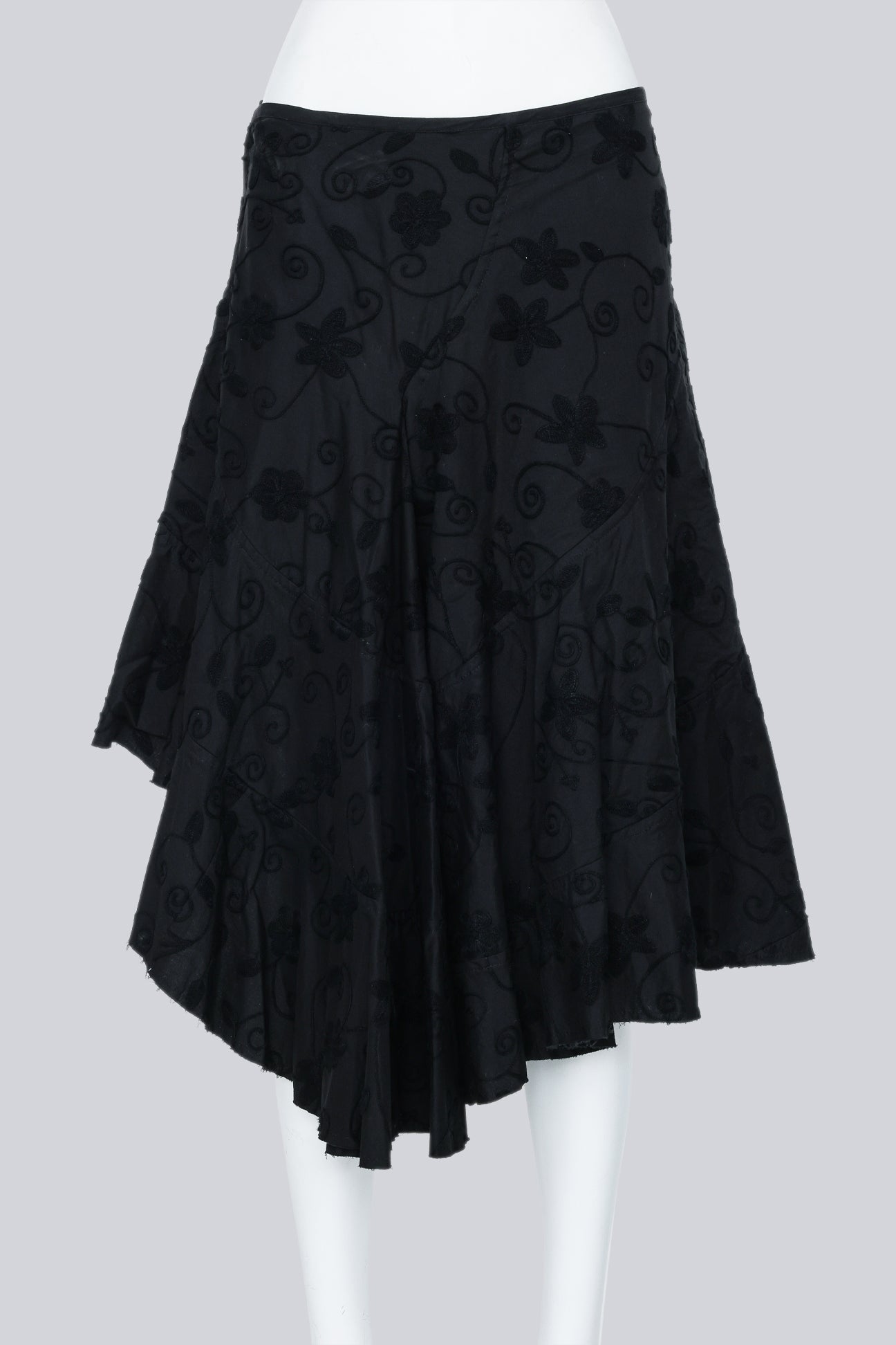 JUNYA WATANABE - A 2002 BLACK EMBROIDERED ASYMMETRICAL WRAP SKIRT WITH A BUCKLE ACCENT
